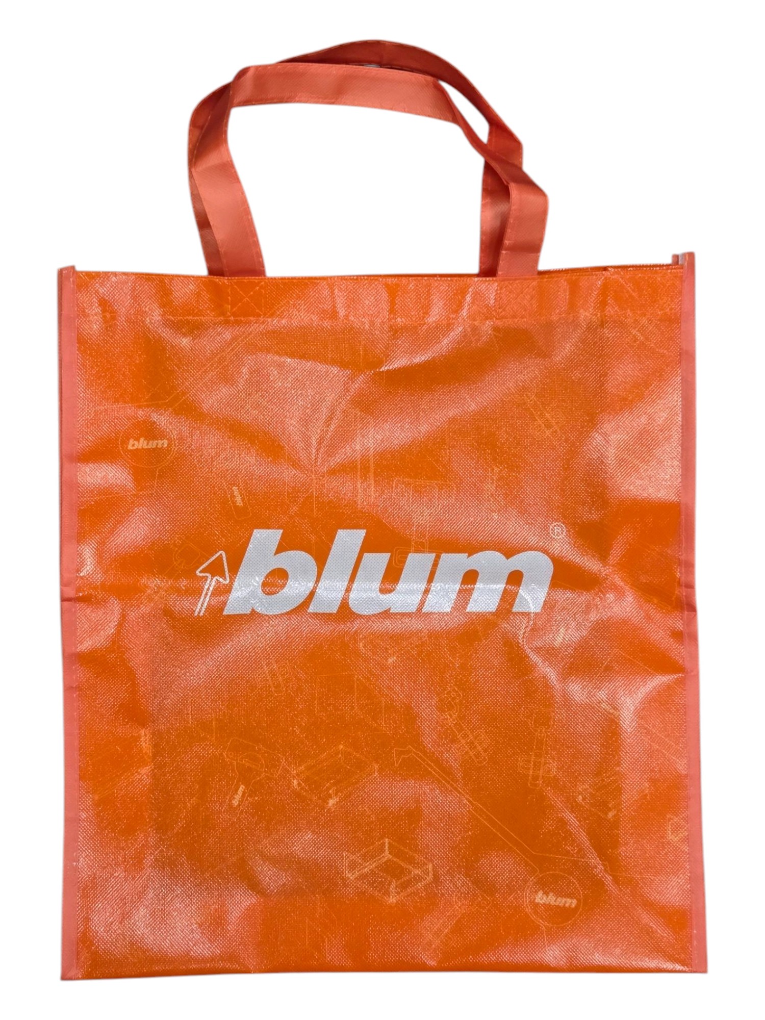 Orange cotton tote bag with blum logo in white and two sturdy handles at the top.