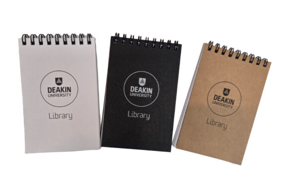 3 pocket sized notebooks with company logo