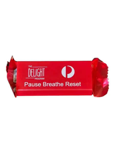 red sweets in red packaging with company logo