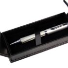 Silver pen with textured grip in a black case, lid open.