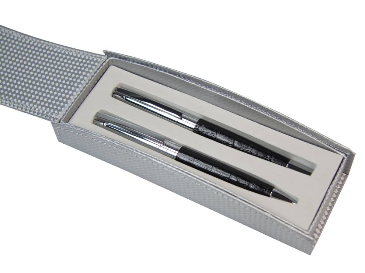 Two black and silver pens in a textured silver gift box with a white interior.