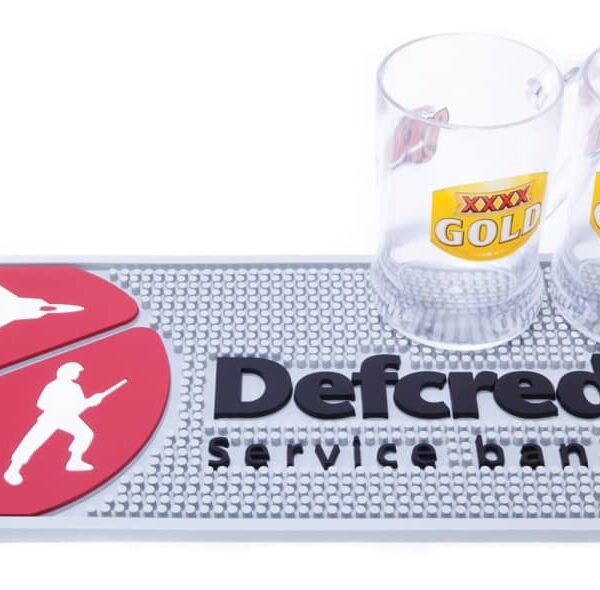 Two beer glasses on a mat with military symbols and Defcredit service banking text.