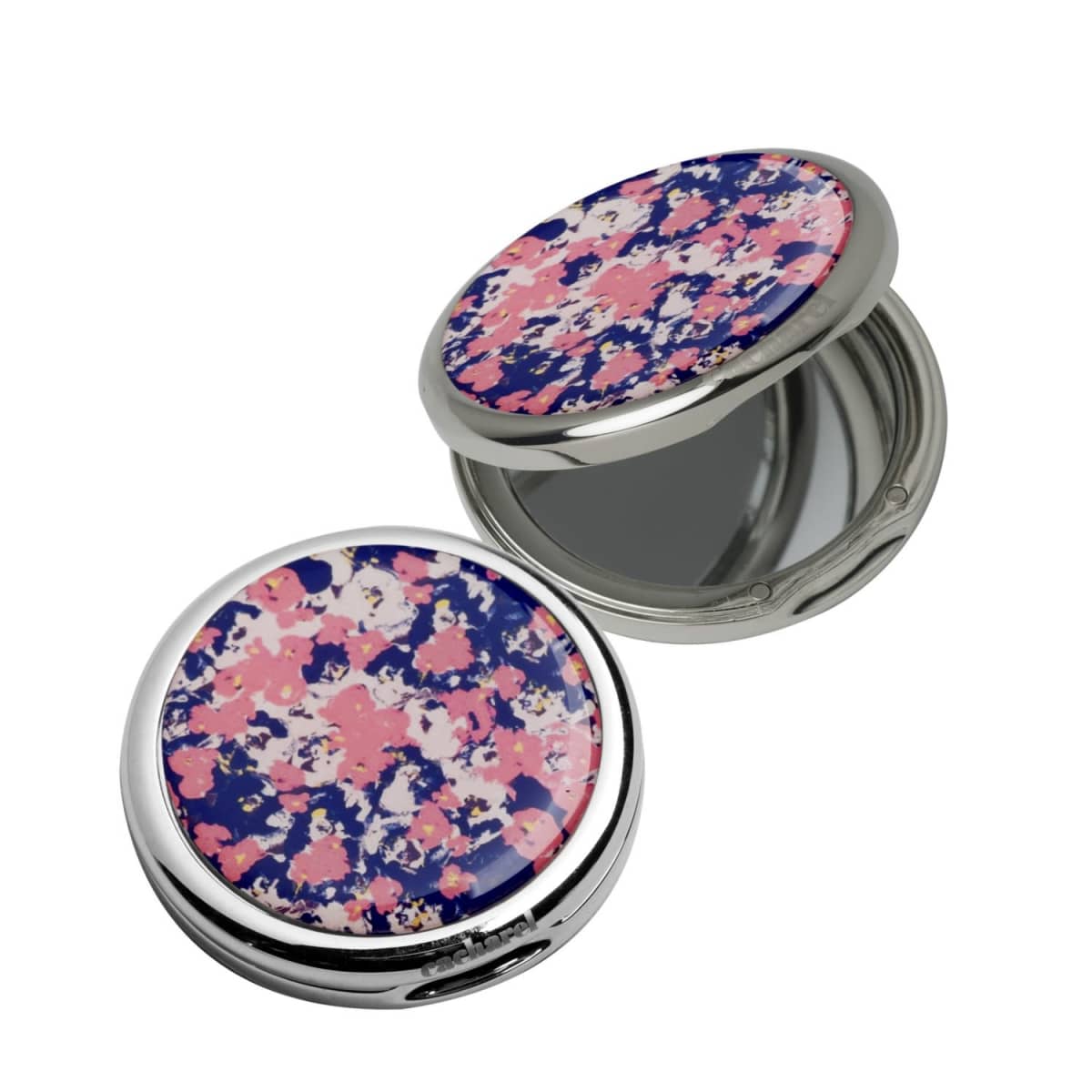 Two round compact mirrors with pink, blue, and white floral patterns on the lids.