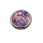 Round compact mirror with a pink, white, and blue floral pattern on the lid.