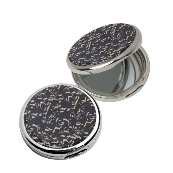 Two round compact mirrors with dark, patterned covers, one open and one closed.