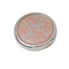Round silver compact mirror with a pink floral pattern on the lid, shown closed.