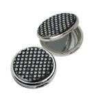 Two round compact mirrors with black and white patterned lids, one open and one closed.