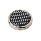 Round metallic object with a black, patterned top and a shiny silver rim.