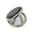 Round compact mirror with a black, patterned lid, open to show both mirrors inside.