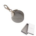 Round gray Cacharel keychain pouch with zipper, metal clip, and branded gift box.