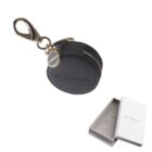 Round black Carhartt coin pouch with zipper, key clip, and branded box with two pins inside.