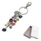 Colorful flower keychain with metal rings and clasp, displayed beside a white gift box.