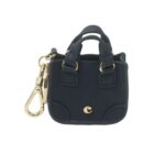 Mini navy blue handbag keychain with gold hardware and clasp.