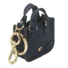 Miniature navy handbag keychain with gold hardware and a keyring attached.