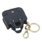 Mini navy handbag keychain with gold keyring and clasp attached.