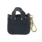 Small navy blue handbag keychain with gold clasp on a white background.