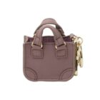 Small mauve handbag keychain with gold hardware and a top handle.