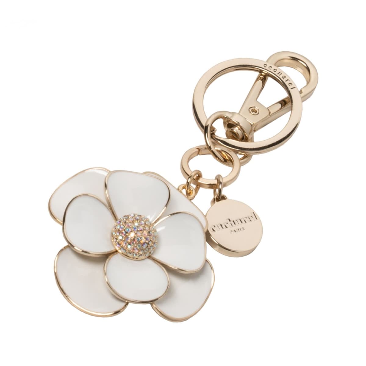 Gold keychain with a white flower charm and a round engraved tag.
