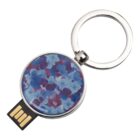 Round USB keychain with a blue and purple floral pattern on its surface.