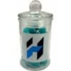 Glass jar with a lid, containing blue items and a label with a geometric H design.