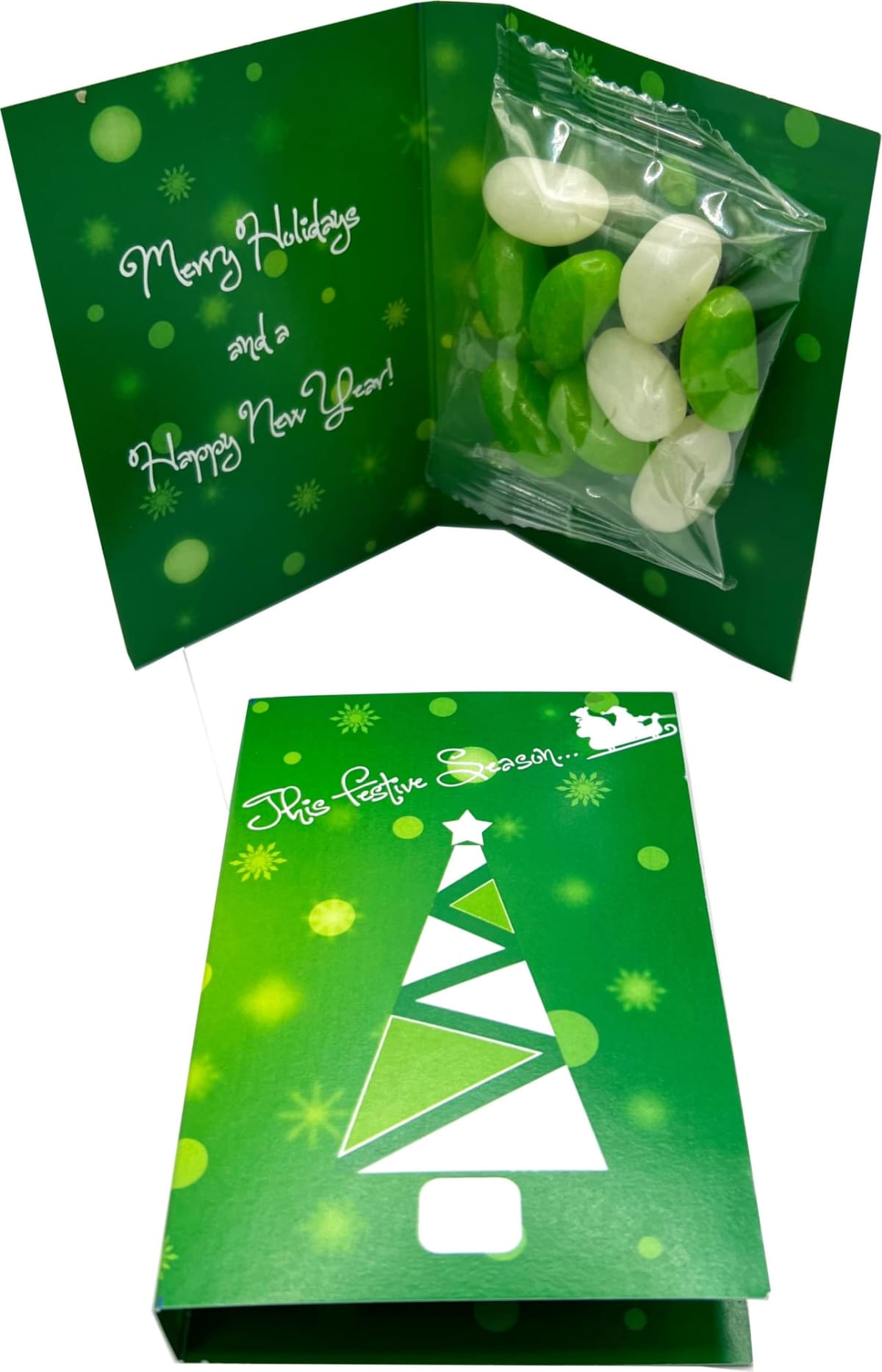 Green holiday card with tree design, open to reveal candies and festive greeting inside.