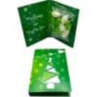 Green holiday card with a white tree design, open to show a festive message and white flowers.