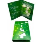 Green holiday card with a tree design, open to show candy inside and a festive message.