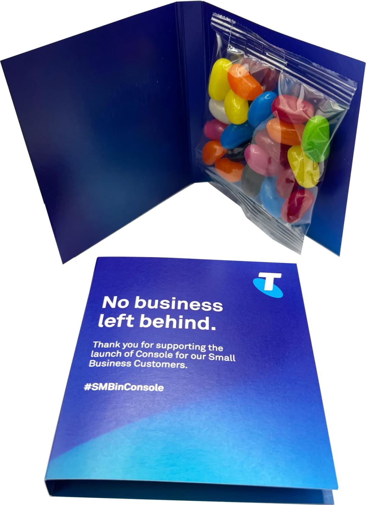 Blue card with Telstra branding, message, and a packet of colorful jellybeans inside.