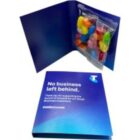Blue Telstra card with text and a ziplock bag of colorful jelly beans inside.