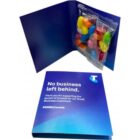 Open blue folder with colorful candy and text: No business left behind.