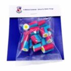 A bag of colorful cylindrical candies with red, blue, and yellow layers on a blue background.
