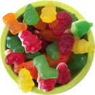 A bowl filled with colorful Christmas-themed gummy candies.