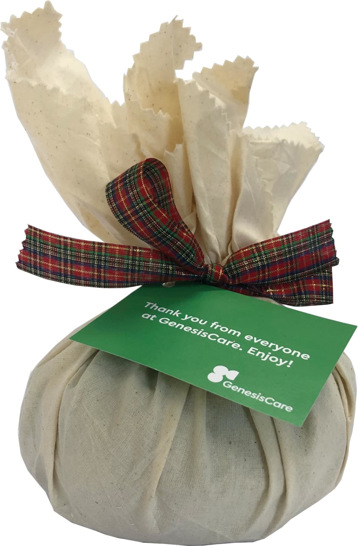 Fabric-wrapped gift with a plaid ribbon and a green GenesisCare thank you tag.