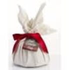 A wrapped gift with a red ribbon and a tag, covered in white cloth with knotted ends.
