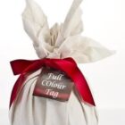 White fabric-wrapped gift with a red ribbon and a tag reading Full Colour Tag.