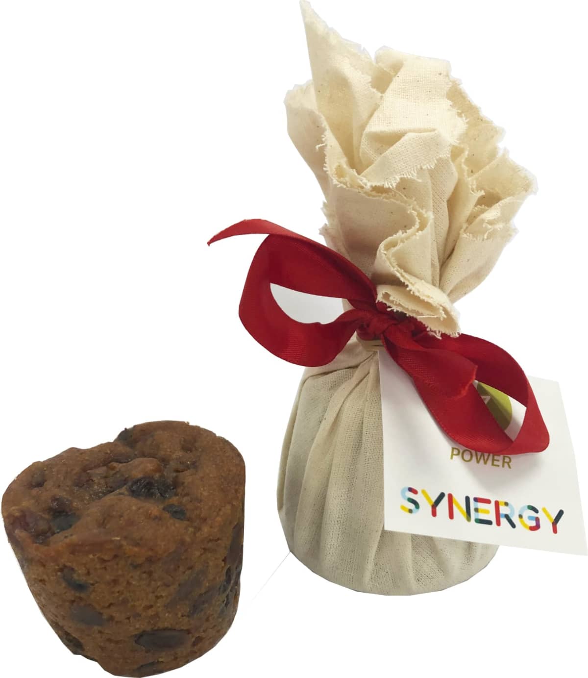 A small wrapped bundle with a red ribbon and a muffin-like cake beside it.
