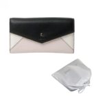 Black and white wallet with a snap closure, shown with a white drawstring pouch.