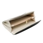 Open black and white wallet with interior zippered pocket and card slots visible.