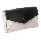 A stylish tricolor wallet with black, white, and light pink panels and a gold accent.