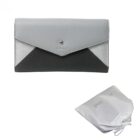 Gray and black envelope-style wallet with a white drawstring pouch beside it.