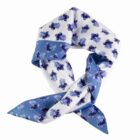 White and blue floral scarf tied in a loose knot on a plain background.