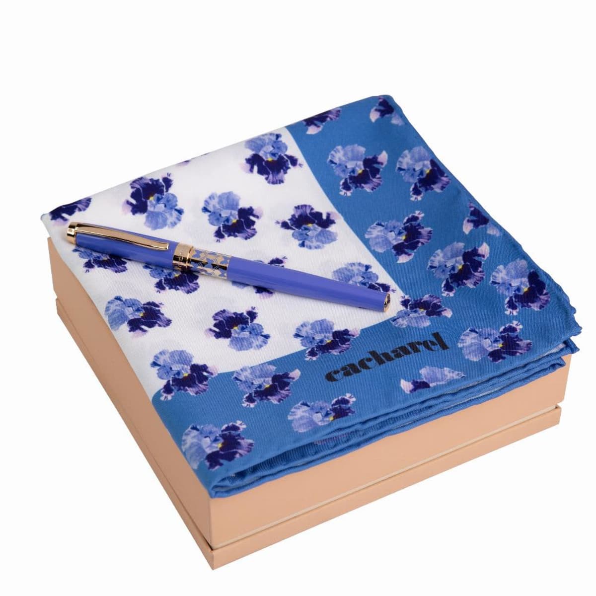 Blue floral scarf and matching pen on a beige box, with cacharel text on the scarf.