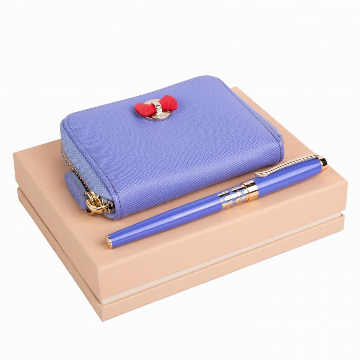 Purple wallet and matching pen on a beige box with a red bow detail on the wallet.