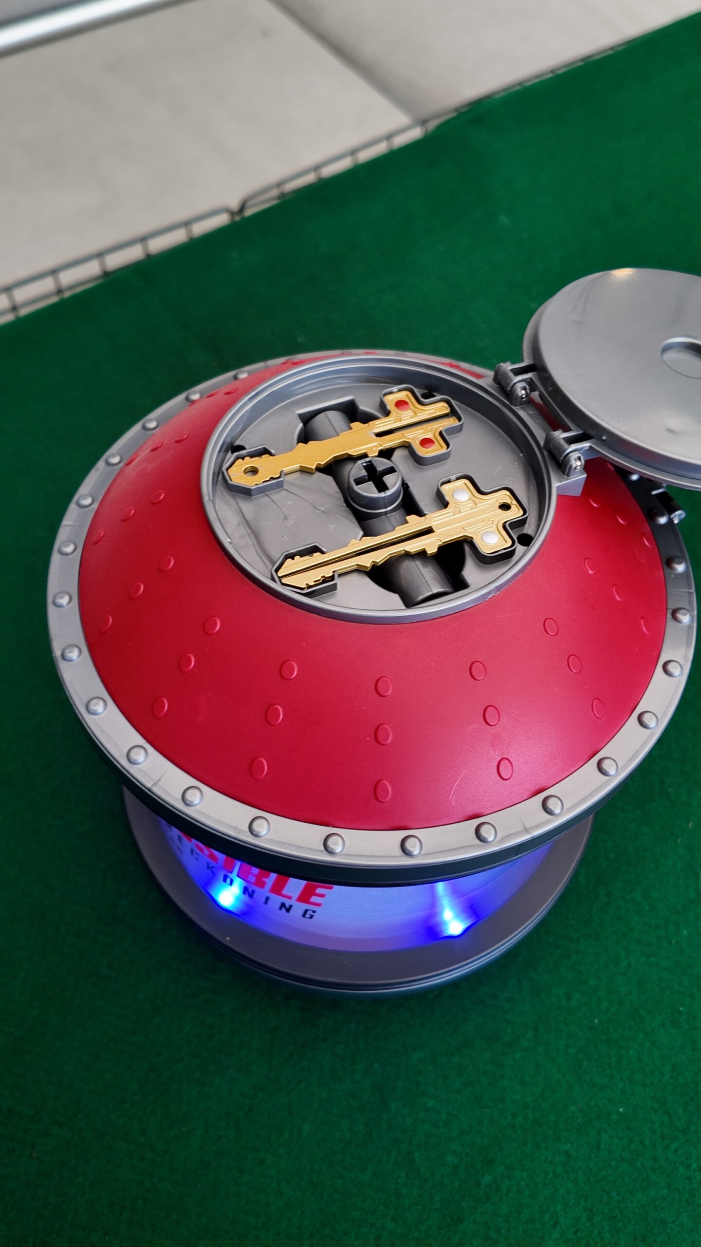 Mission Impossible popcorn dispenser, top view with lid open, revealing keys