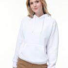 Woman wearing a white hoodie and brown pants, standing against a plain white background.