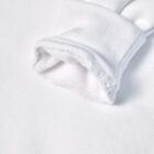 Close-up of a white sweatshirt sleeve with visible inner fleece lining.