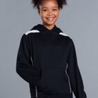 Smiling girl wearing a black hoodie with white details, standing against a gray background.