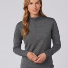 Woman wearing a long-sleeve gray zip-up top, standing against a plain light background.