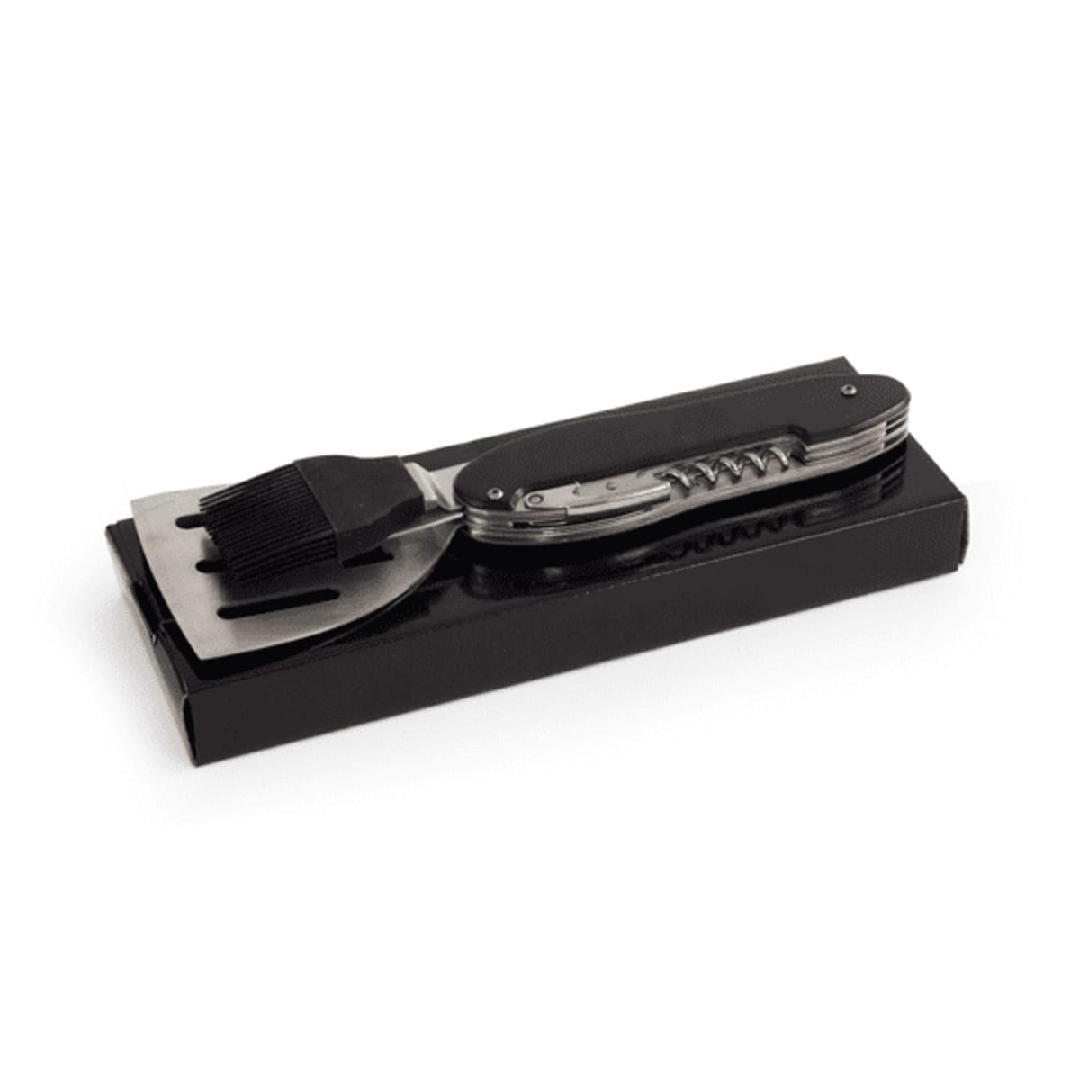 A multi-tool BBQ utensil set with a spatula and basting brush on a black box.