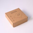 Brown cardboard box for a wireless charger on a plain light background.